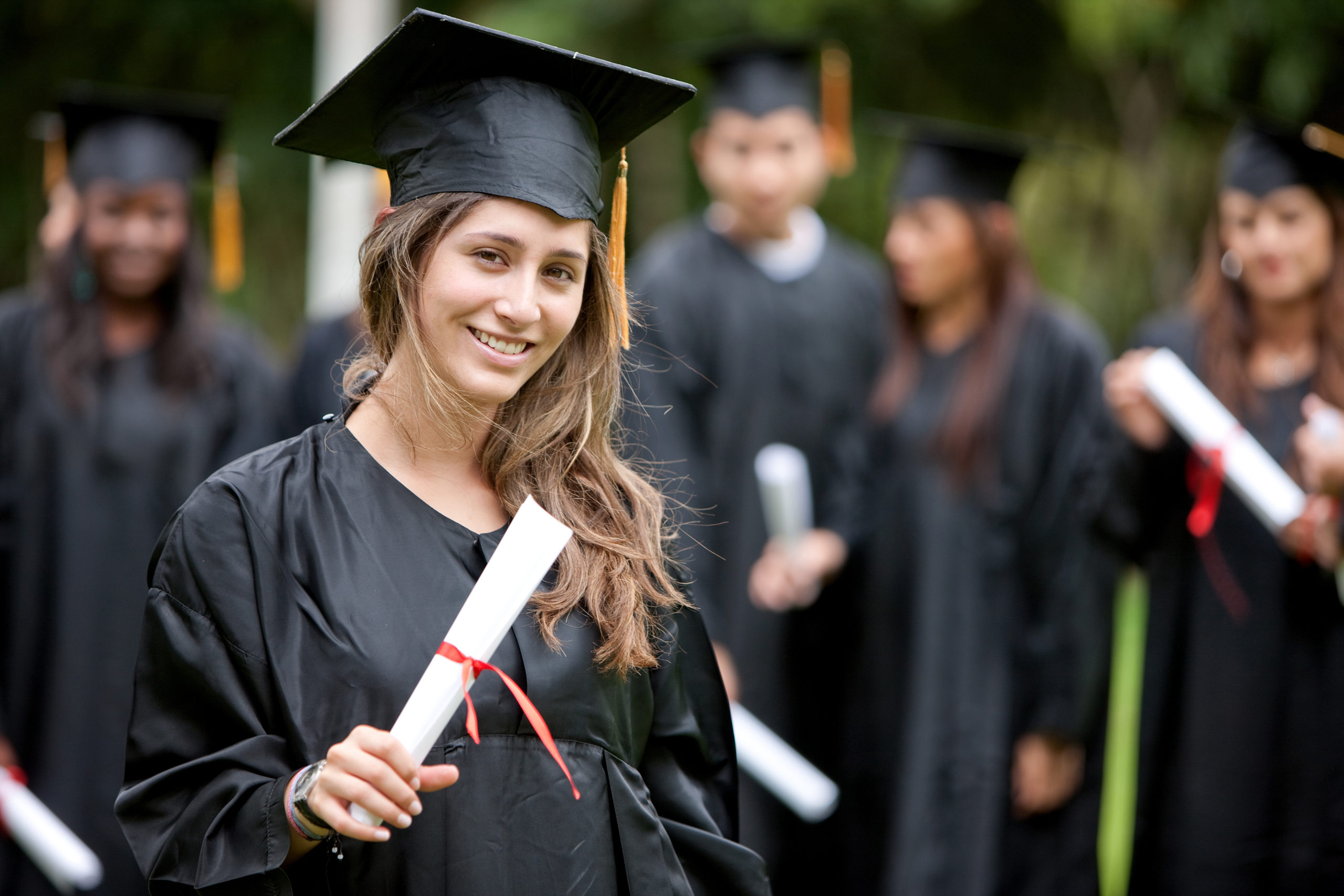 image of girl in cap and gown with diploma