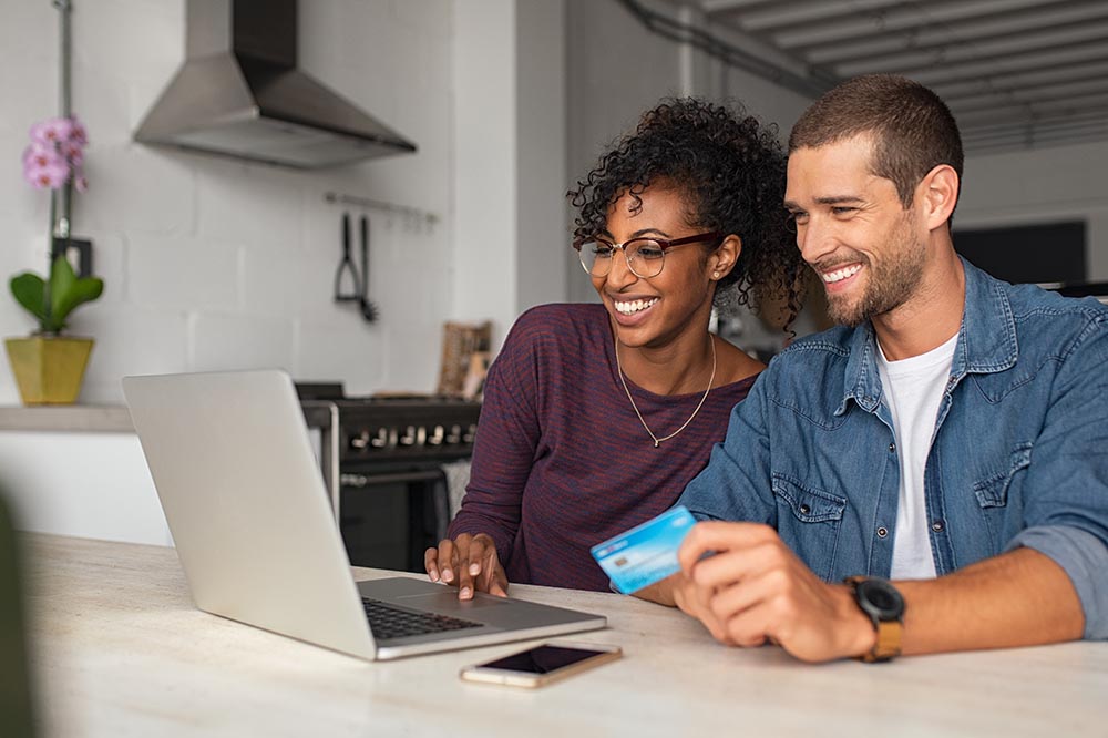 Happy multiethnic ouple making online payment Happy couple making online payment