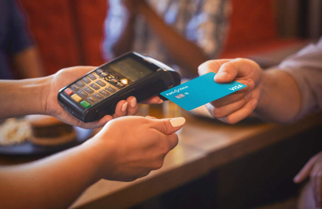 Image showing credit card being used to pay. Credit Card utilization ratio concept.