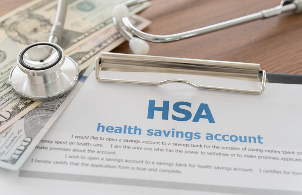 Depiction of a health savings account alongside money and a stethoscope, emphasizing the benefits of opening a health savings account.