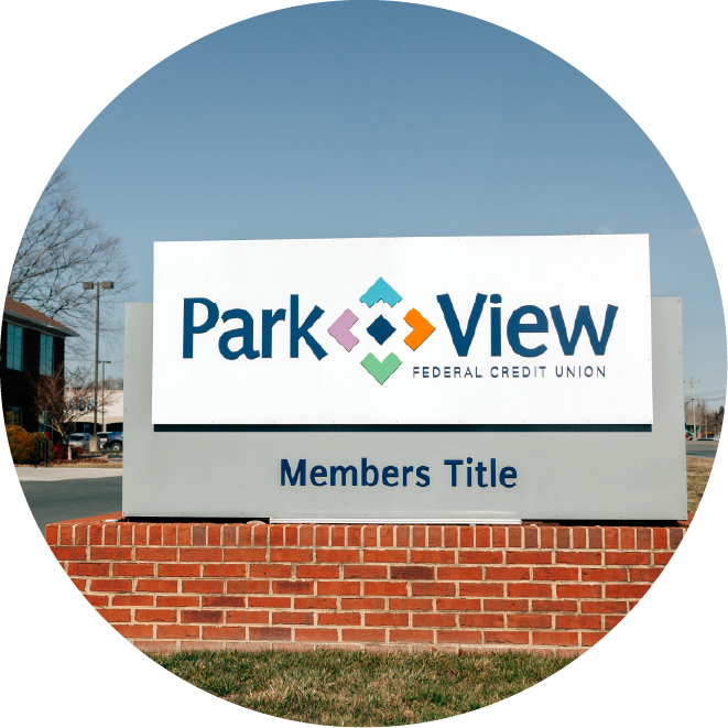 Sign for Park View Credit Union and Members Title stands on a brick base.