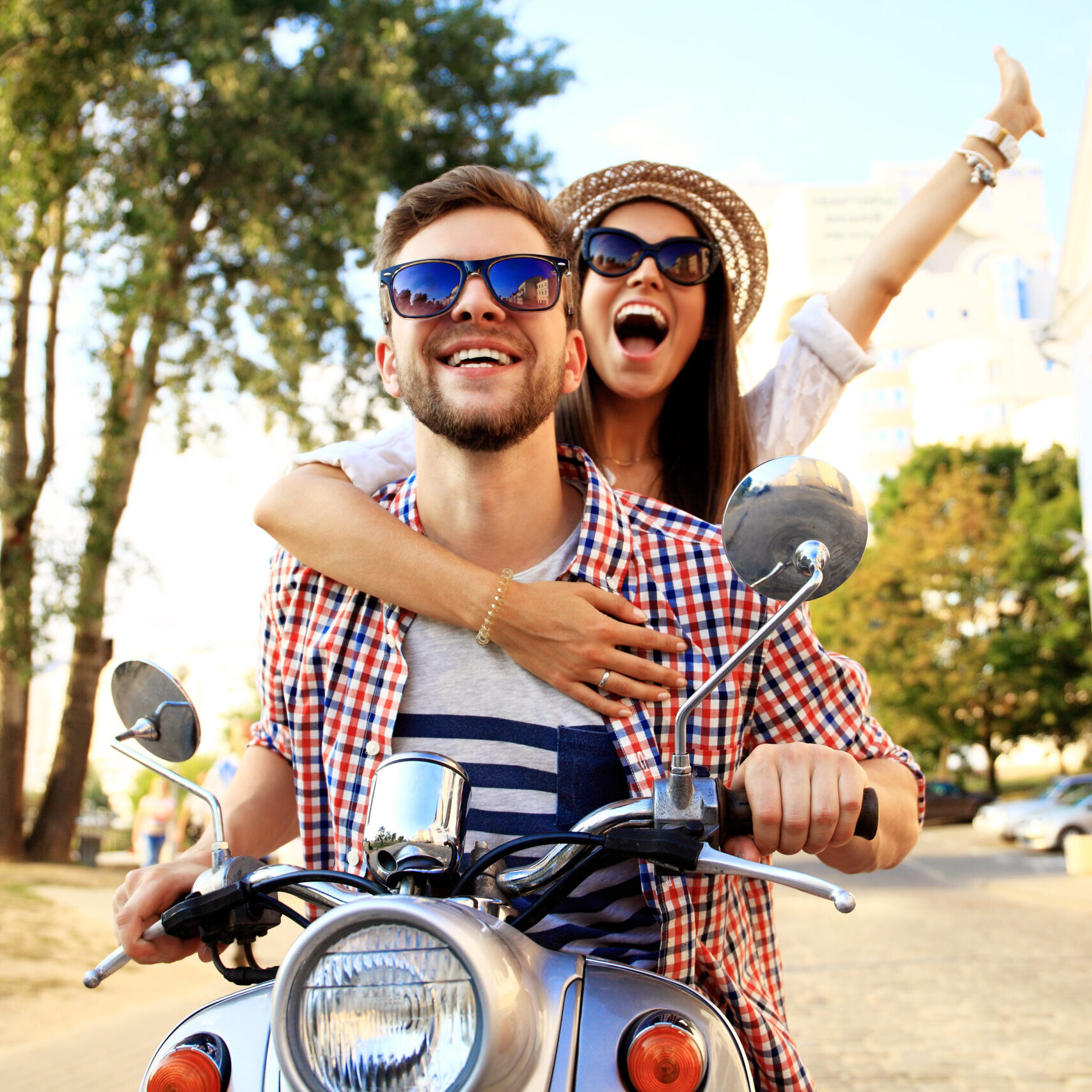 Image of happy young couple on scooter enjoying road trip