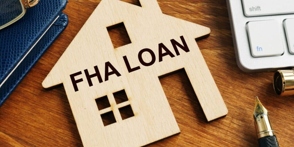 An image of a wood house that says "FHA Loan"