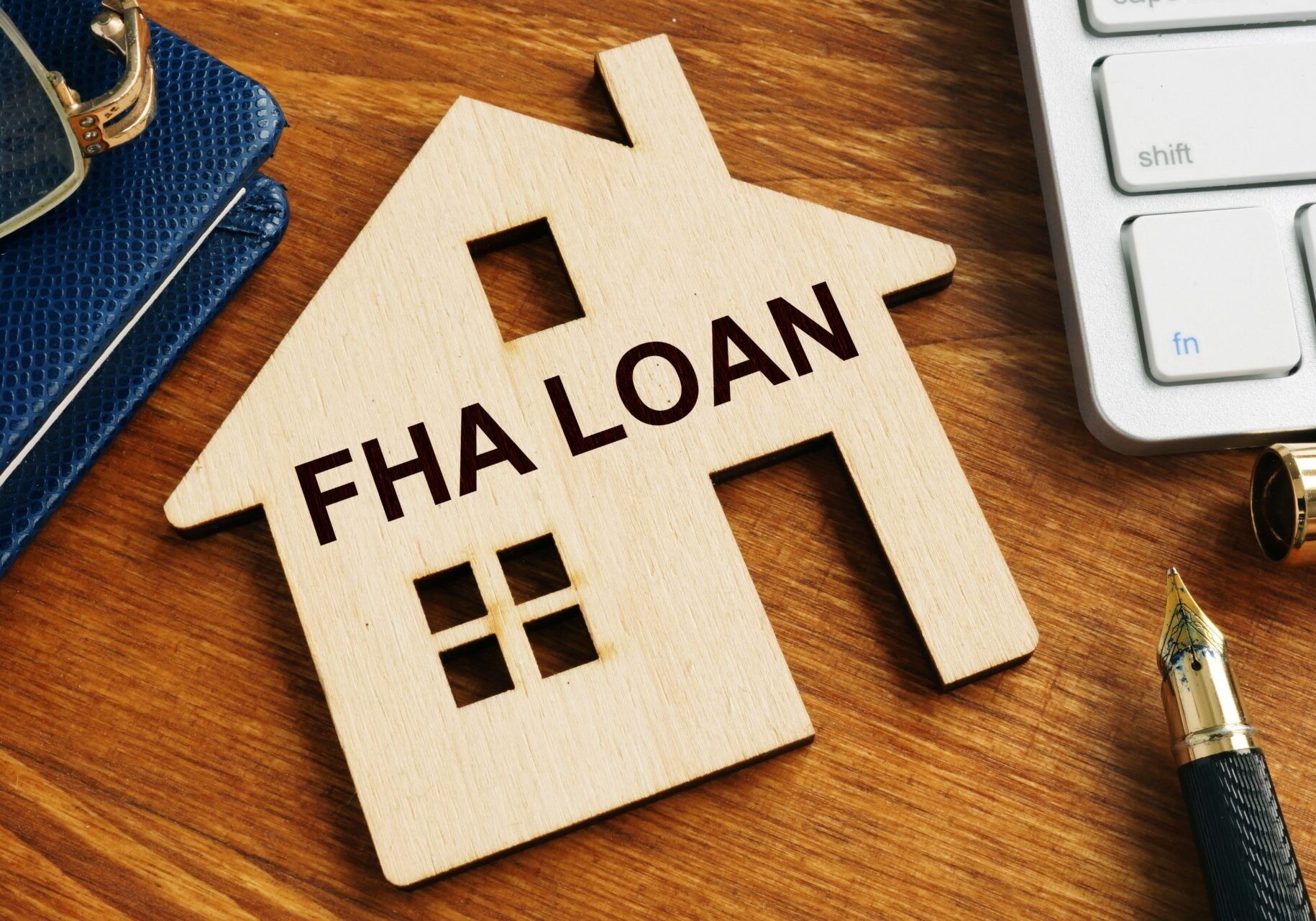 An image of a wood house that says "FHA Loan"