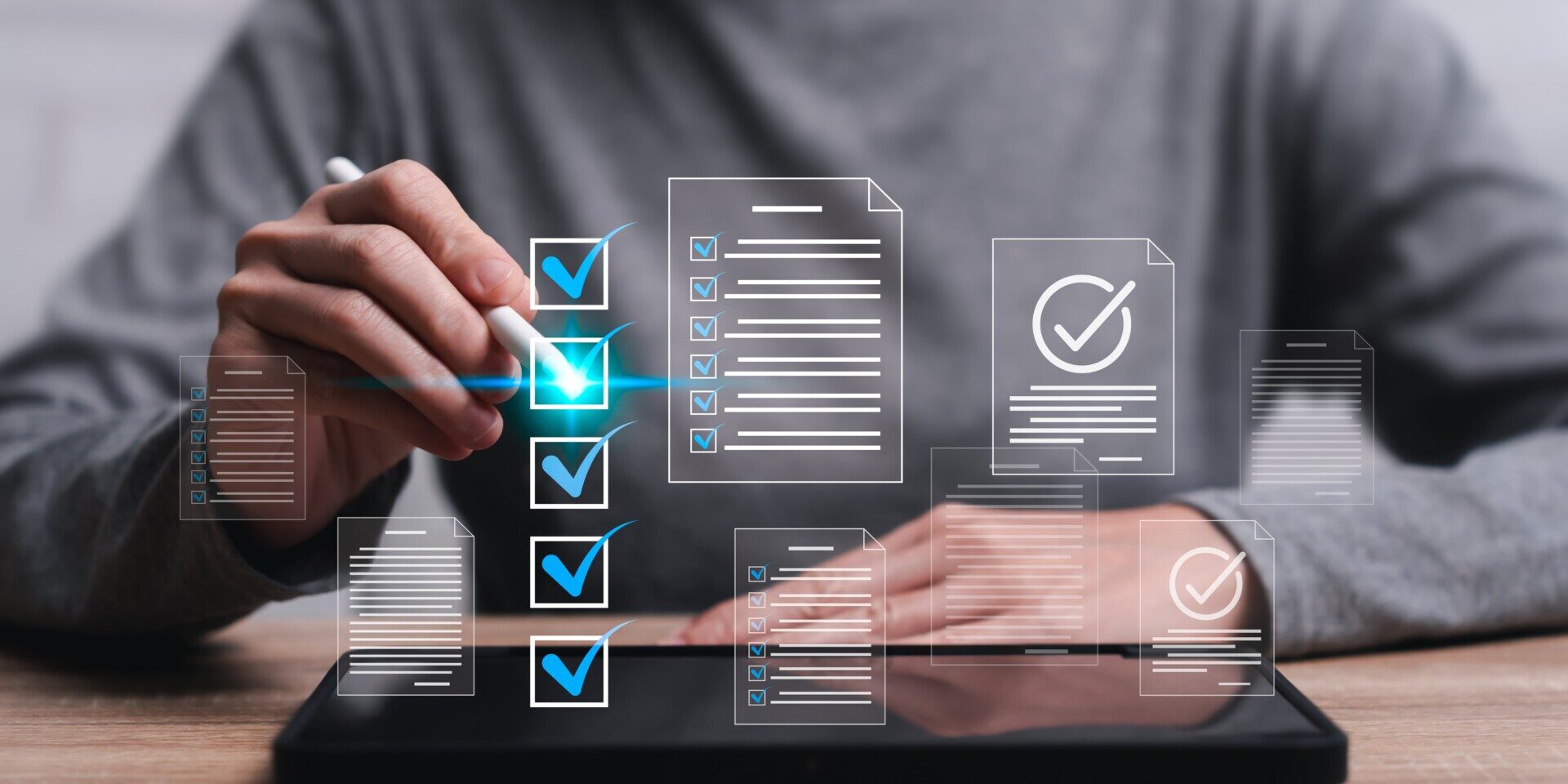 A person using a tablet with checklist and check mark icons, ensuring fraud prevention measures.