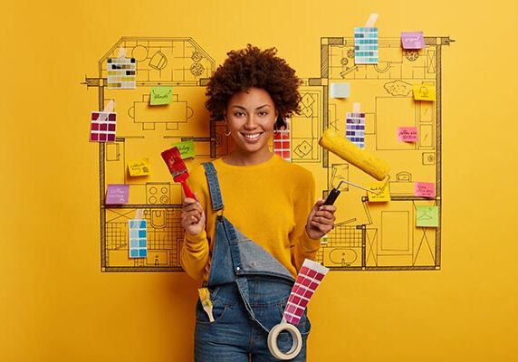 Woman holding paint brushes