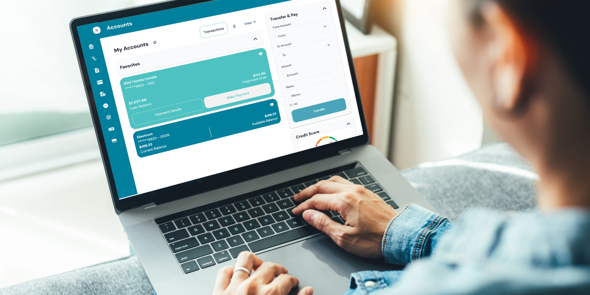 A woman sitting her couch, focused on her laptop while paying her Park View Federal Credit Union loan online.